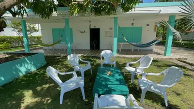 a group of chairs and hammocks in a yard at Costa de Vikingos in Tolú