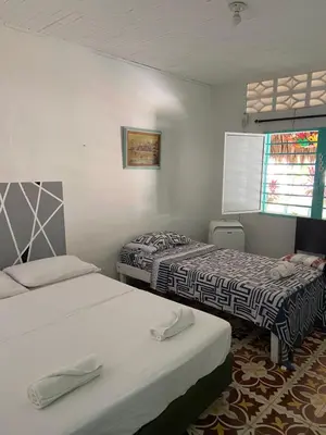 a room with two beds and a window at Costa de Vikingos in Tolú