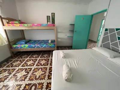 a bedroom with two bunk beds and a door at Costa de Vikingos in Tolú