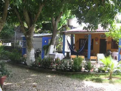 a house with a hammock in front of it at Hostal Roldan in Coveñas