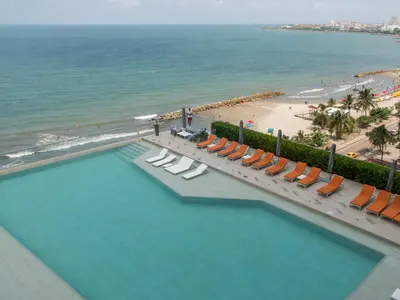 an overhead view of a pool with chairs and a beach at Namaste Alojamientos Luxury Cartagena in Cartagena de Indias