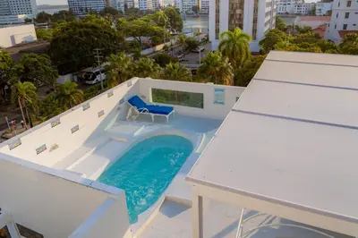 a pool on the roof of a building at Hotel Coral Reef Cartagena in Cartagena de Indias