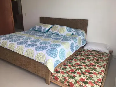 a bed in a room with a quilt on it at Costa Azul Suite 606 in Santa Marta