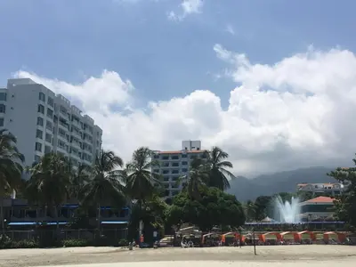 a city with palm trees and buildings and a fountain at Costa Azul Suite 606 in Santa Marta