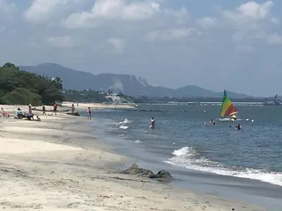 a group of people on a beach with a kite in the water at Costa Azul Suite 606 in Santa Marta