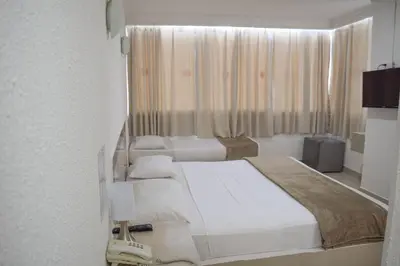a hotel room with two beds and a window at Hotel Cartagena Premium in Cartagena de Indias