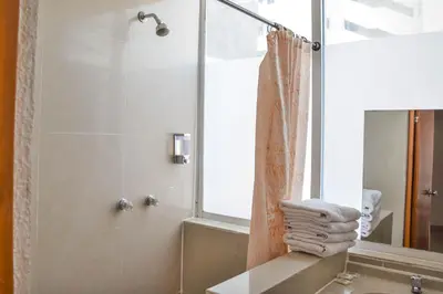 a bathroom with a shower and a sink and a mirror at Hotel Cartagena Premium in Cartagena de Indias