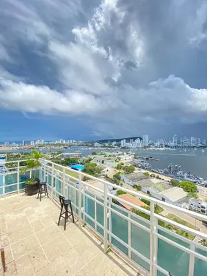 a balcony with two chairs and a view of the water at Hotel Cartagena Premium in Cartagena de Indias