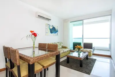 a living room with a table and a couch at Travelers Orange Cartagena in Cartagena de Indias