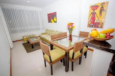 a living room with a glass table and chairs at Travelers Orange Cartagena in Cartagena de Indias
