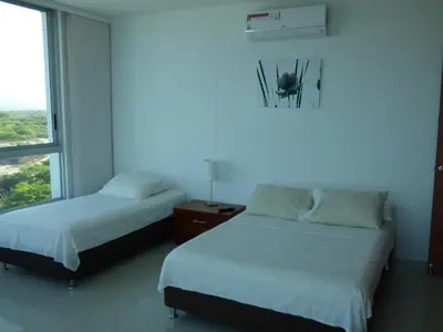 a bedroom with two beds and a window at Costa Azul Suites 906 in Santa Marta