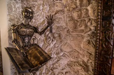 a metal skeleton holding a box on a wall at Hotel 3 Banderas in Cartagena de Indias