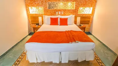 a bedroom with a large bed with red pillows at Hotel 3 Banderas in Cartagena de Indias
