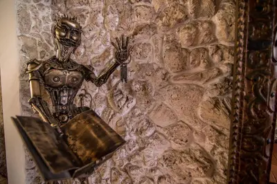 a metal robot on a stone wall at Hotel 3 Banderas in Cartagena de Indias