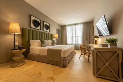 a bedroom with a bed and a desk and a table at Madisson Boutique Hotel Cartagena in Cartagena de Indias