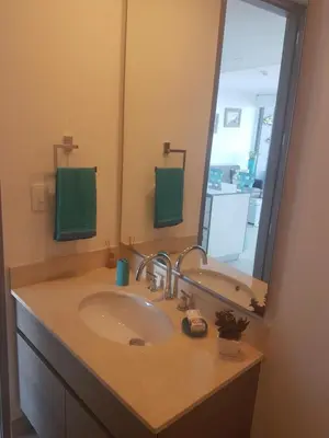 a bathroom with a sink and a large mirror at Morros City - Frente al mar in Cartagena de Indias