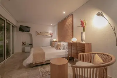 a bedroom with a bed and a table and chairs at Casa Claver Loft Boutique Hotel in Cartagena de Indias