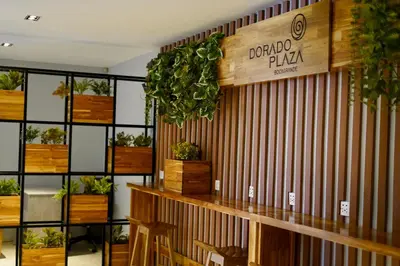 a restaurant with a wooden wall with plants on it at Hotel Dorado Plaza Bocagrande - All Inclusive in Cartagena de Indias