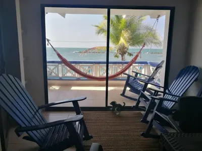 a room with chairs and a view of the ocean at Cabañas Cigua in Coveñas