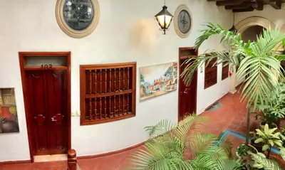 a hallway in a house with some plants at Casa Del Curato in Cartagena de Indias