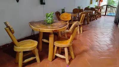a wooden table and chairs in a room at Casa Del Curato in Cartagena de Indias
