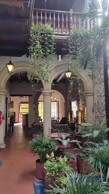 a lobby with potted plants in a building at Casa Del Curato in Cartagena de Indias