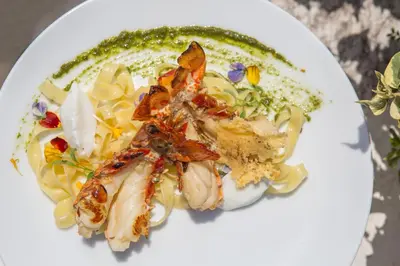 a white plate of food with shrimp and pasta at Movich Hotel Cartagena de Indias in Cartagena de Indias