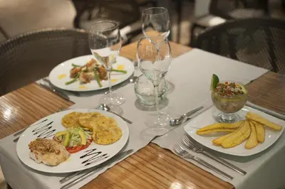 a table with two plates of food on top at Movich Hotel Cartagena de Indias in Cartagena de Indias