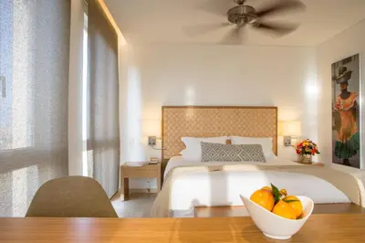 a bedroom with a bed with a bowl of fruit on a table at Movich Hotel Cartagena de Indias in Cartagena de Indias