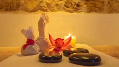 a candle and some vegetables on a towel next to a candle gmaxwell gmaxwell at Movich Hotel Cartagena de Indias in Cartagena de Indias