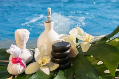 a bottle of soap and flowers next to the ocean at Movich Hotel Cartagena de Indias in Cartagena de Indias