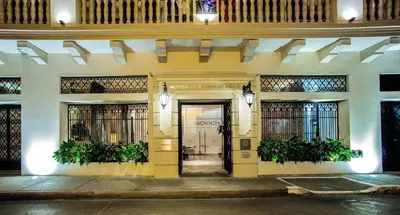 a yellow building with a door with plants on it at Movich Hotel Cartagena de Indias in Cartagena de Indias