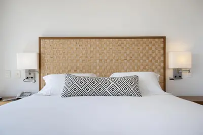 a bedroom with a large white bed with two lamps at Movich Hotel Cartagena de Indias in Cartagena de Indias