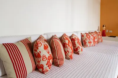 a row of pillows sitting on a bed at Hotel Quadrifolio in Cartagena de Indias