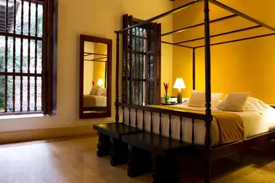 a bedroom with a bed and a large mirror at Hotel Quadrifolio in Cartagena de Indias