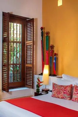 a bedroom with a bed and a window with surfboards at Hotel Quadrifolio in Cartagena de Indias