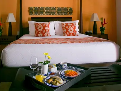 a hotel room with a bed with a tray of food at Hotel Quadrifolio in Cartagena de Indias