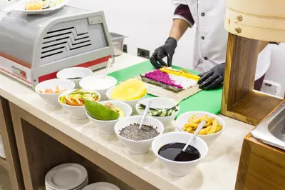 a chef preparing food in white bowls on a counter at Hotel Cartagena Plaza in Cartagena de Indias