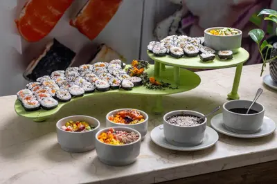 a table with a tray of pastries and bowls of food at Hotel Cartagena Plaza in Cartagena de Indias