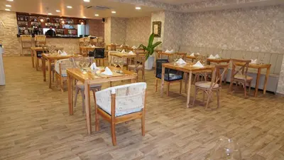a dining room with wooden tables and chairs at Hotel Cartagena Plaza in Cartagena de Indias