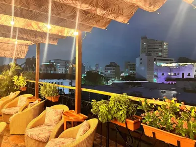 a balcony with chairs and a view of a city at Hotel Don Pedro De Heredia in Cartagena de Indias