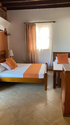 two beds in a room with a window at Hotel Don Pedro De Heredia in Cartagena de Indias