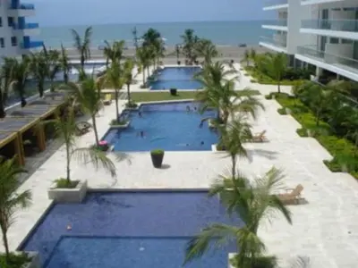 two pools with palm trees in front of a building at Morros Epic 222 in Cartagena de Indias