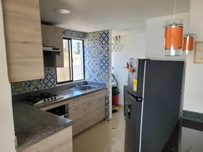 a small kitchen with a refrigerator and a sink at Edificio Marina del Rey Cartagena in Cartagena de Indias