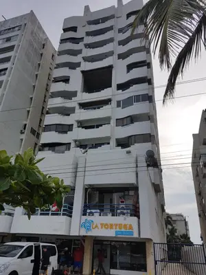 a tall white building with a sign on it at Edificio Marina del Rey Cartagena in Cartagena de Indias