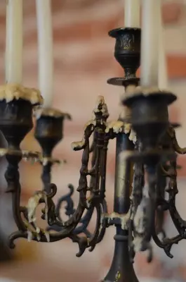 a group of candlesticks with white candles at Alfiz Hotel in Cartagena de Indias