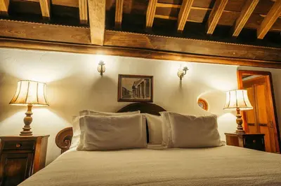 a bedroom with a large bed with two lamps at Alfiz Hotel in Cartagena de Indias