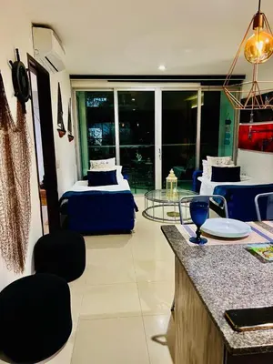 a room with two beds and a table with chairs at MORROS VITRI Luxury in Cartagena de Indias