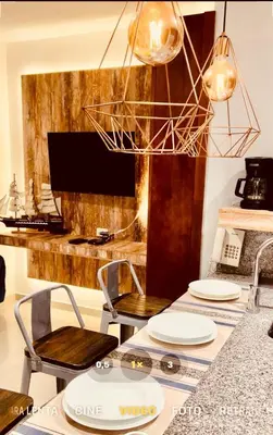 a kitchen with a table with chairs and a television at MORROS VITRI Luxury in Cartagena de Indias