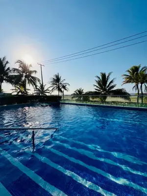 a large swimming pool with palm trees in the background at MORROS VITRI Luxury in Cartagena de Indias